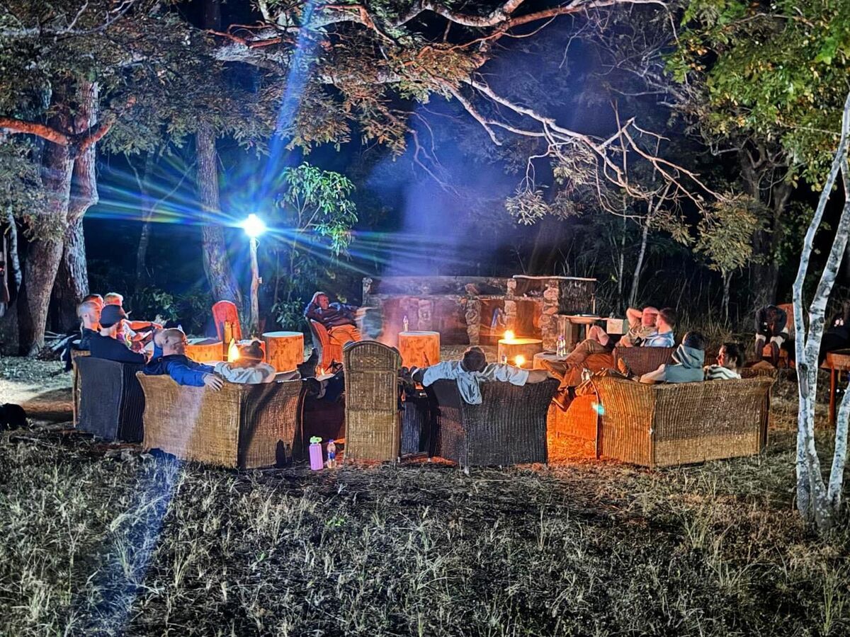 People gathered around a bush fire